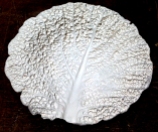 Pressed Savoy cabbage leaf into porcelain.